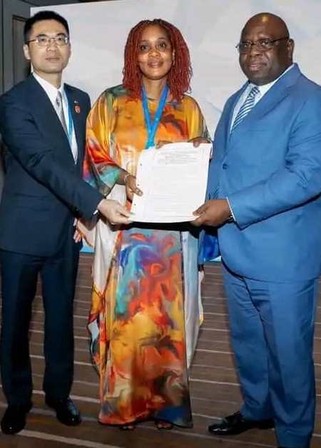 MFMR Minister, Princess Dugba ( Center) receiving the certificate from Chinese Ambassador Wang Qing (Left) while Ambassador  Karim (Right) looks on