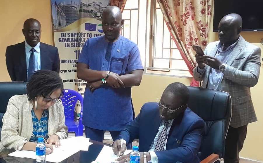 (R-L) Mr. K.O. Bah (R) and Ms. Abigail Kajumba Signing the MoU