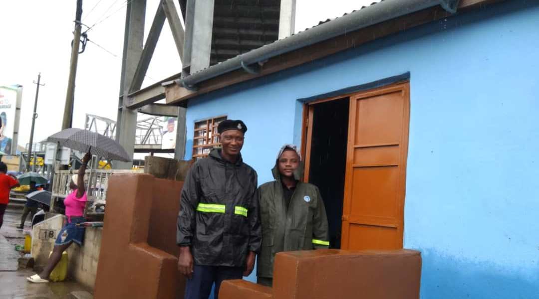 DTO Grafton Mohamed Bangura and personnel pose in front of newly erected building